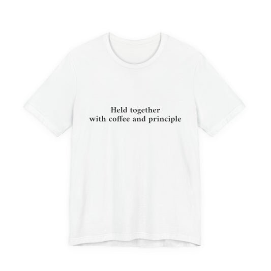 A white short-sleeve crewneck t-shirt with the black printed text 'Held together with coffee and principle' on the chest, displayed against a solid white background.