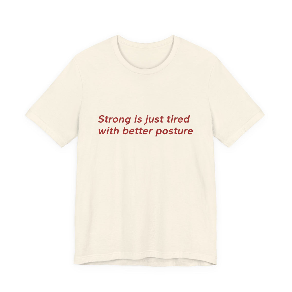 An off-white short-sleeve crewneck t-shirt with the text 'Strong is just tired with better posture' printed in red across the chest, displayed on a clean white background.