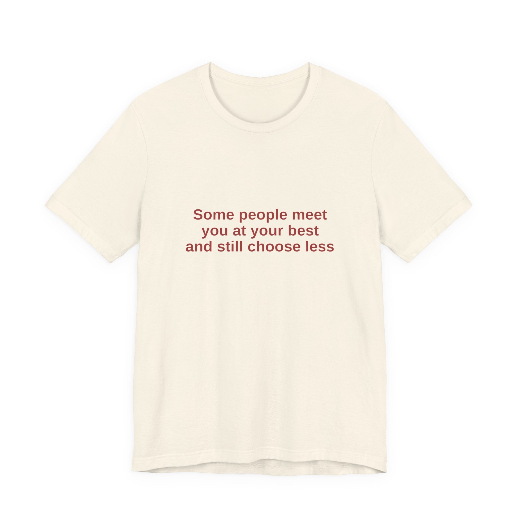 An off-white crewneck t-shirt with red text on the chest that reads 'Some people meet you at your best and still choose less', displayed against a solid white background.