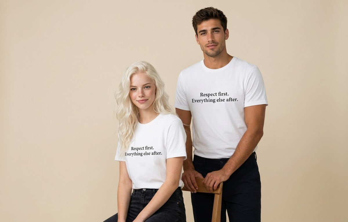 A man and a woman modeling matching white graphic t-shirts with the black printed text 'Respect first. Everything else after.